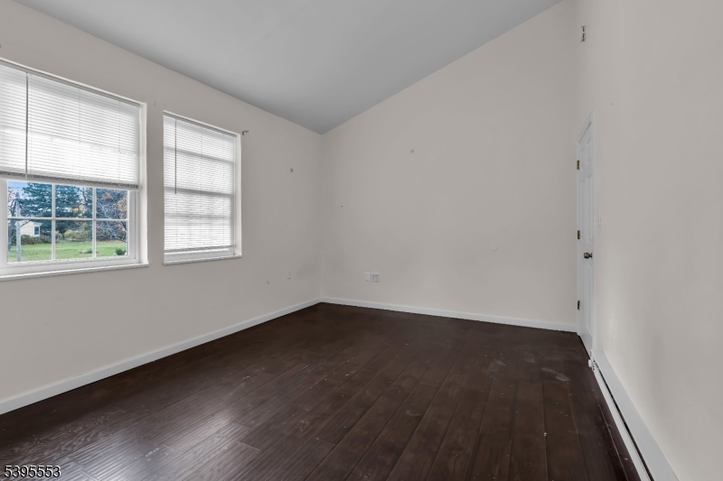 932 Wheatsheaf Road Roselle, NJ 07203 - Photo 32 of 44 an empty room with wooden floor and windows