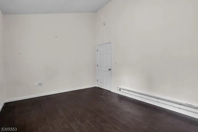 an empty room with wooden floor