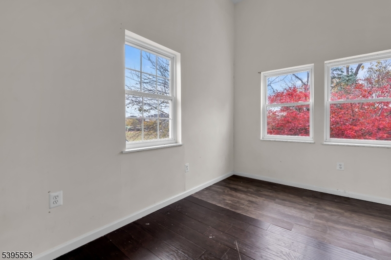 932 Wheatsheaf Road Roselle, NJ 07203 - Photo 35 of 44 a view of an empty room with wooden floor and window
