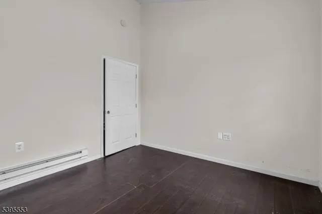an empty room with wooden floor