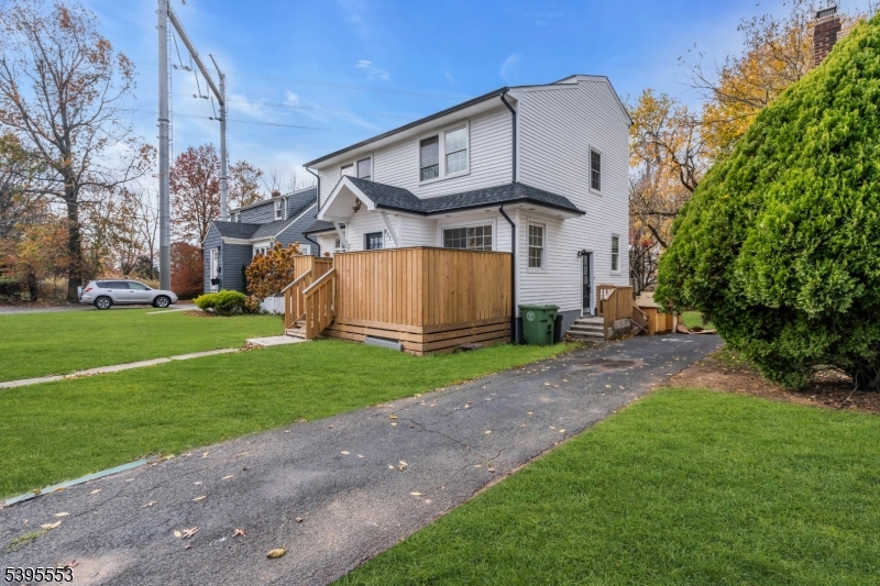 932 Wheatsheaf Road Roselle, NJ 07203 - Photo 5 of 44 a view of a large house with a big yard and large trees