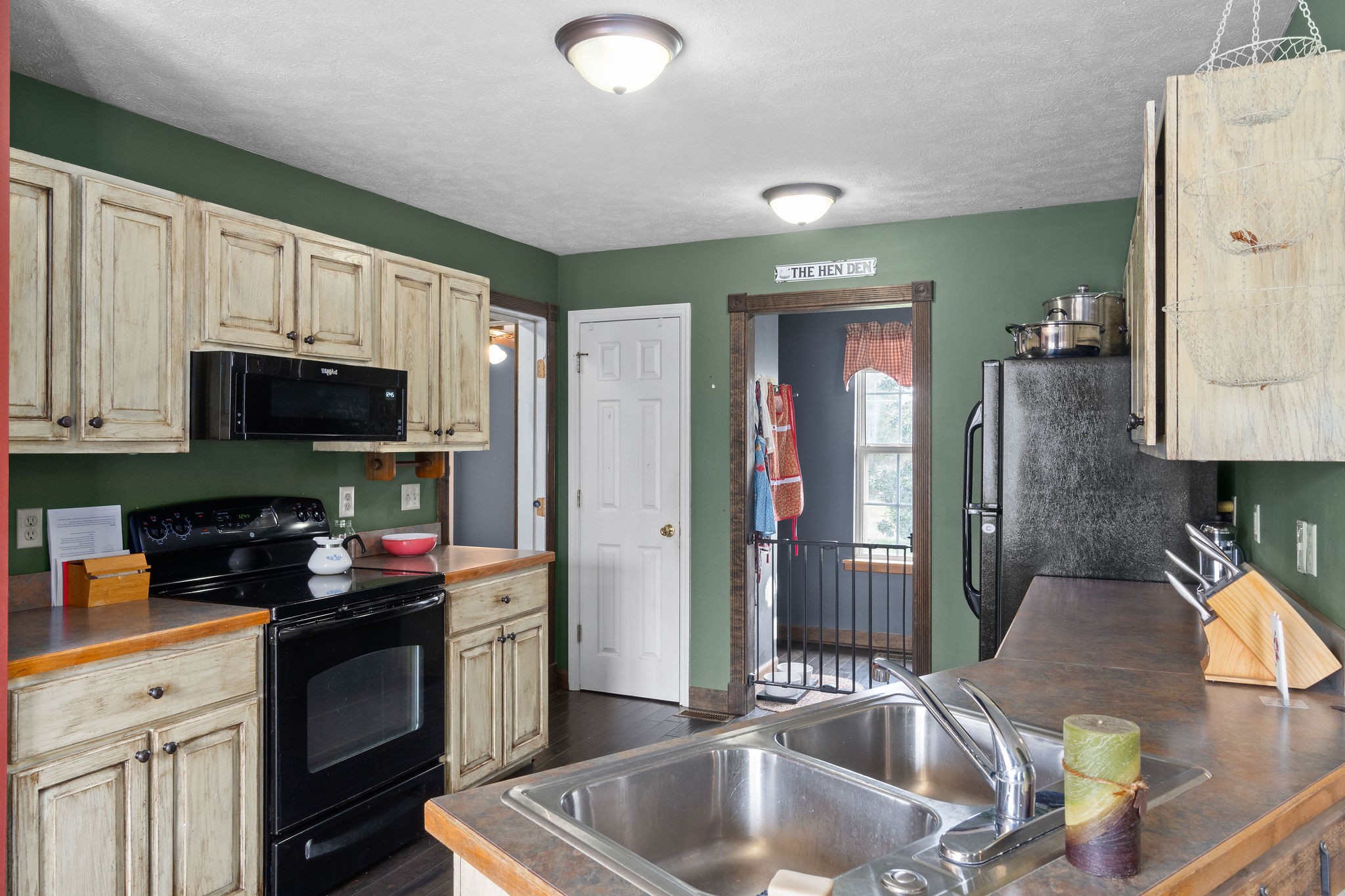 4450 Old Metal Road Palmyra, TN 37142 - Photo 11 of 38 a kitchen with stainless steel appliances granite countertop a sink refrigerator and cabinets