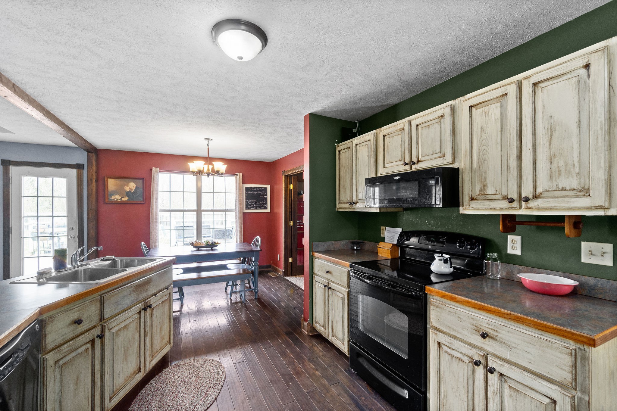 4450 Old Metal Road Palmyra, TN 37142 - Photo 12 of 38 a kitchen with stainless steel appliances granite countertop a stove a sink dishwasher and a microwave oven with cabinets
