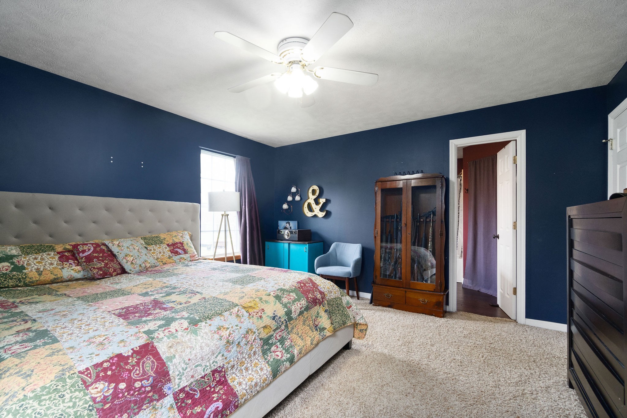 4450 Old Metal Road Palmyra, TN 37142 - Photo 23 of 38 a bedroom with a bed dresser and a chandelier