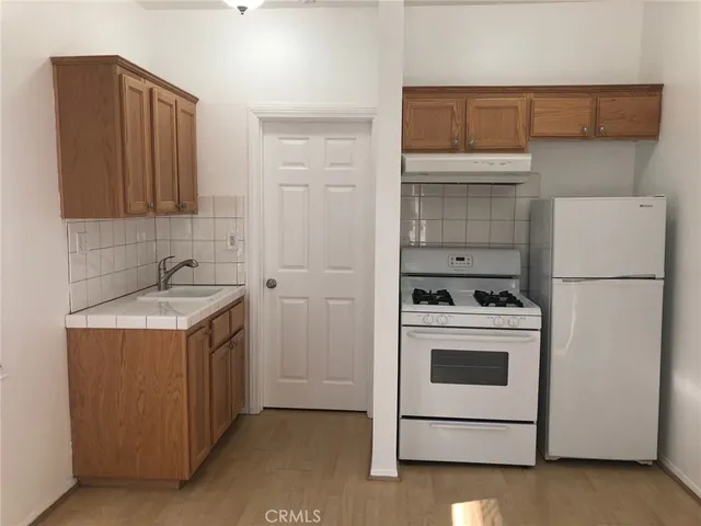 a kitchen with a stove cabinets and refrigerator