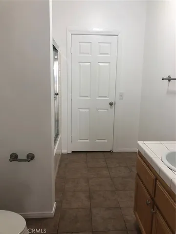 a bathroom with a granite countertop sink