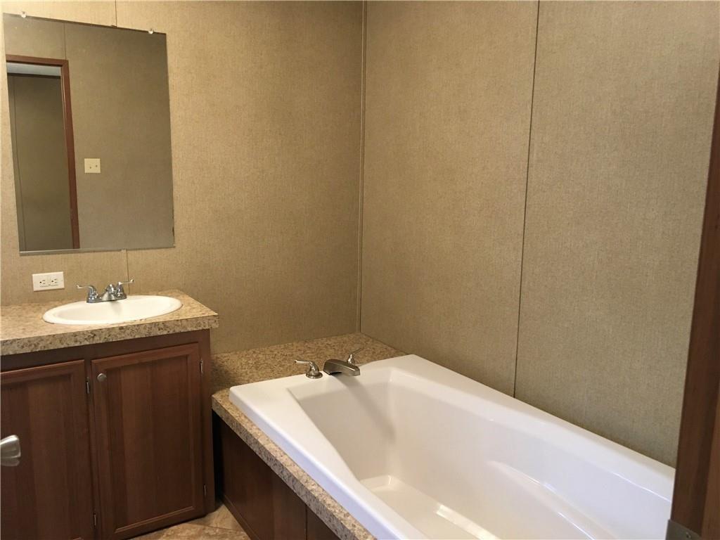 1719 Watterson Road, Unit 1 Red Rock, TX 78662 - Photo 8 of 12 Full bath featuring vanity and a bath