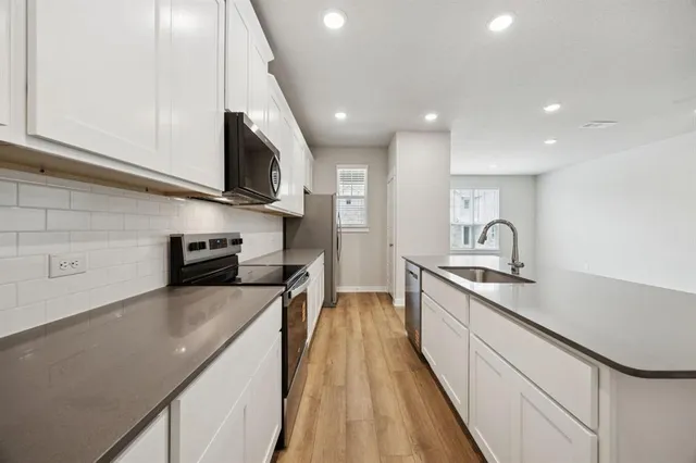 a kitchen with stainless steel appliances granite countertop a sink and cabinets