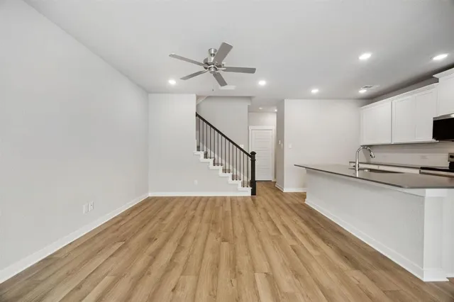 a view of empty room with wooden floor and window