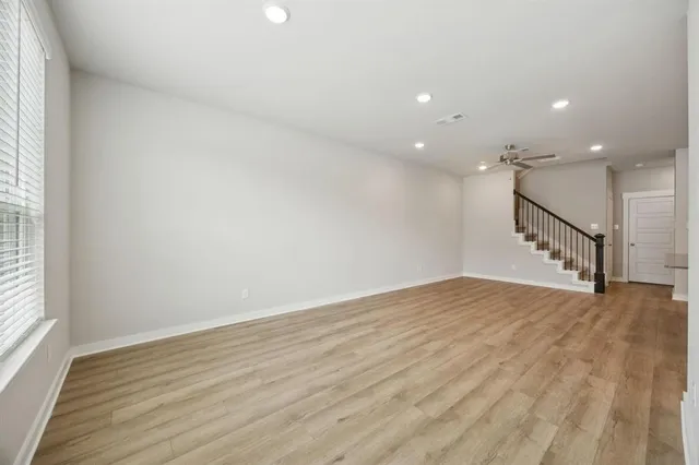 a living room with furniture a flat screen tv and a table