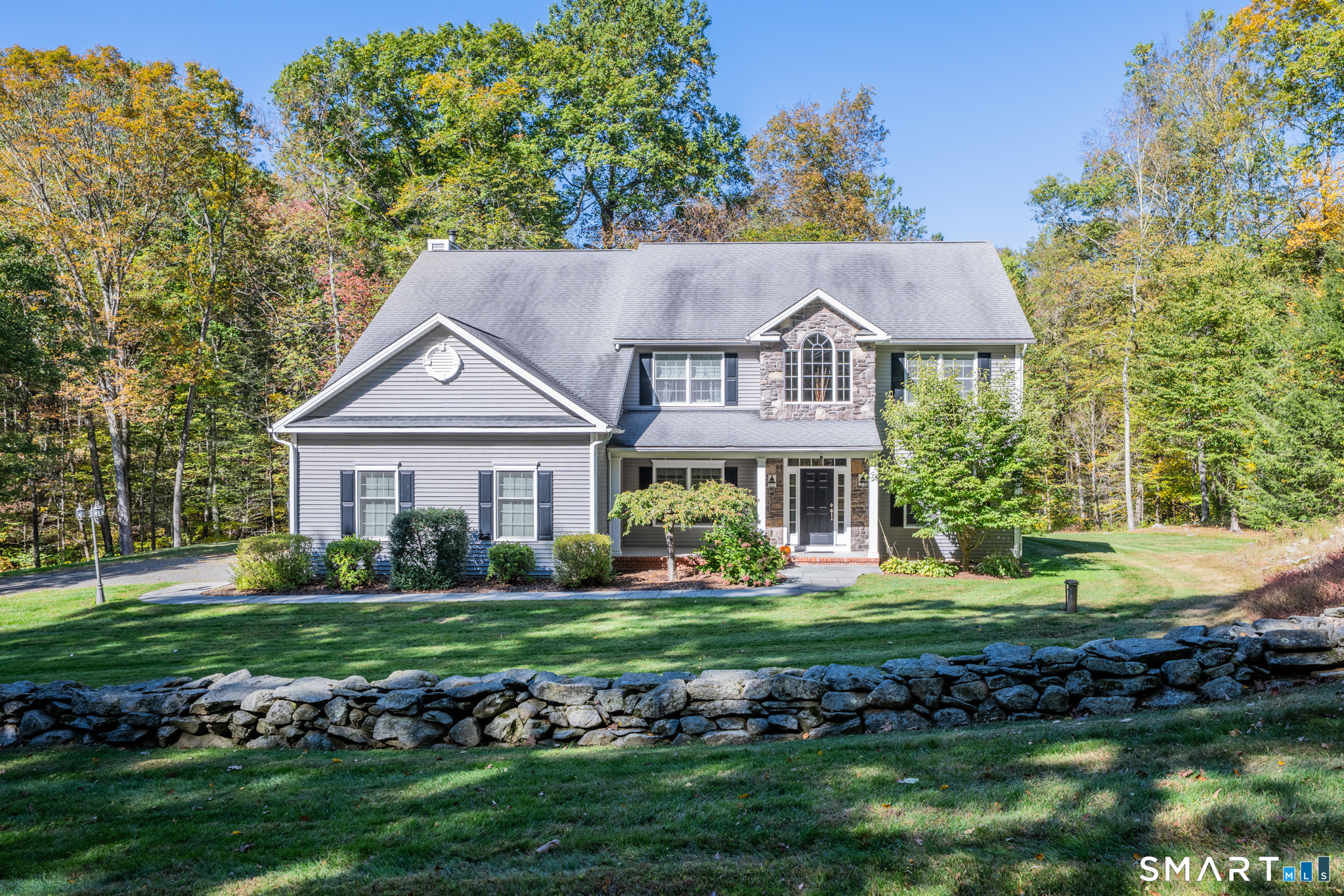 99 Plumb Brook Road Woodbury, CT 06798 - Photo 1 of 1 a front view of a house with a yard table and chairs