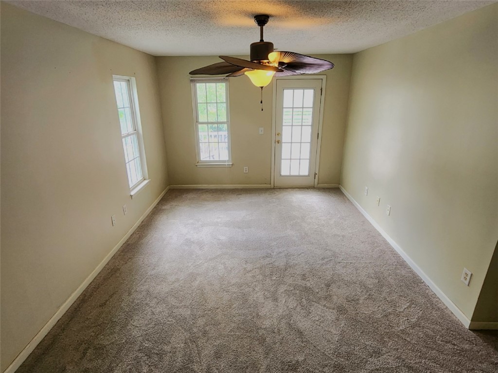 328 Springfield Circle Easley, SC 29642 - Photo 17 of 29 A comfortable living space featuring soft carpeting, ample natural light, and a convenient exterior door.
