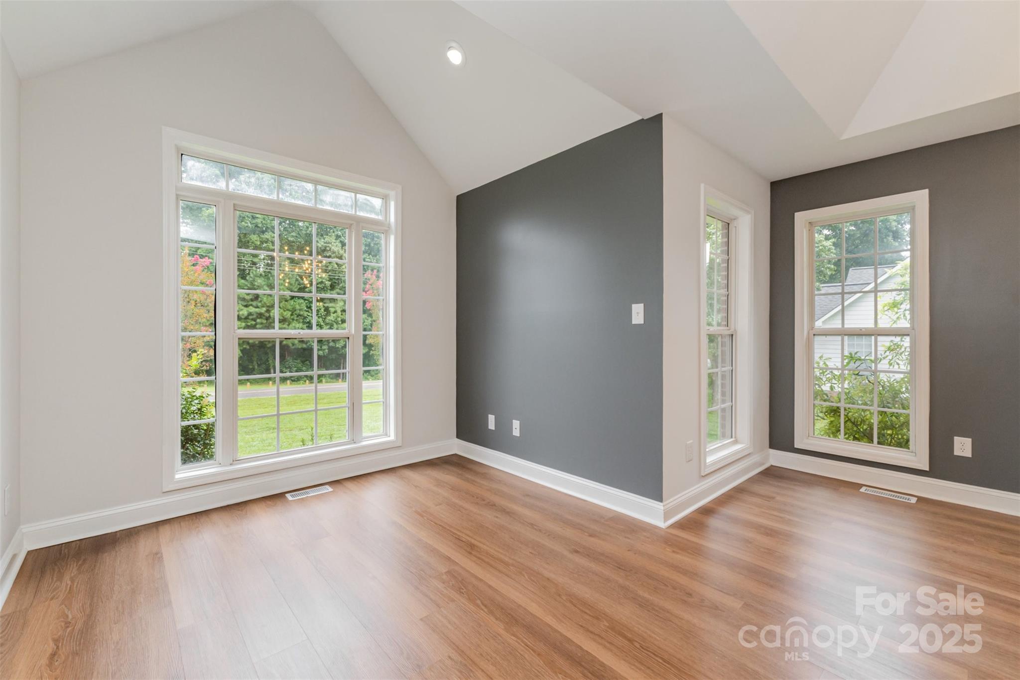 125 Stumpy Creek Road Mooresville, NC 28117 - Photo 11 of 23 an empty room with wooden floor and windows