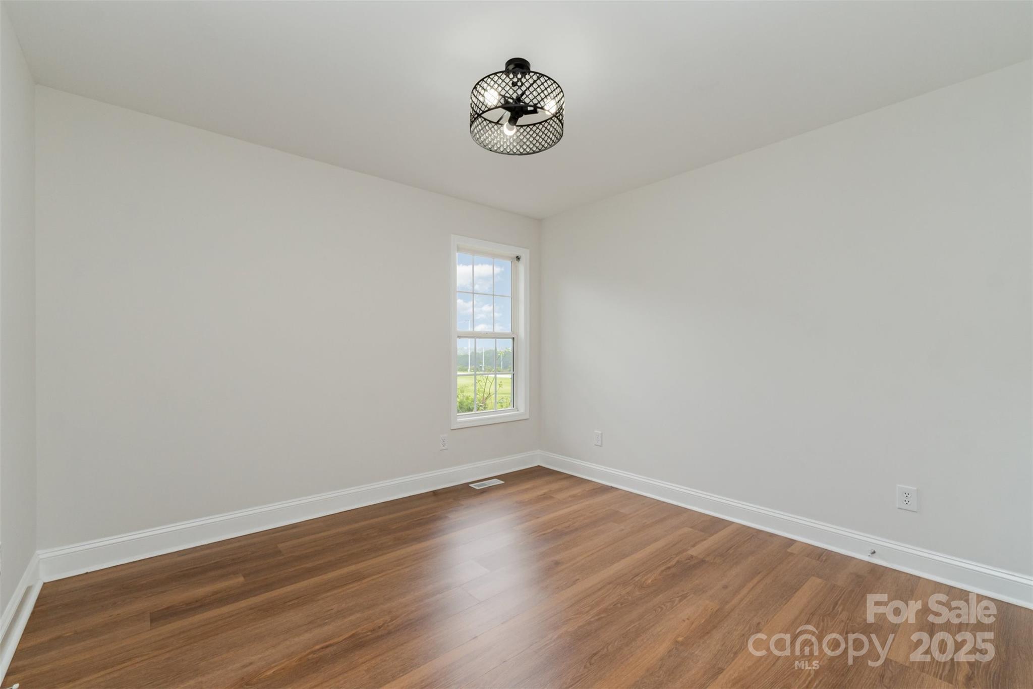 125 Stumpy Creek Road Mooresville, NC 28117 - Photo 20 of 23 an empty room with wooden floor and a window