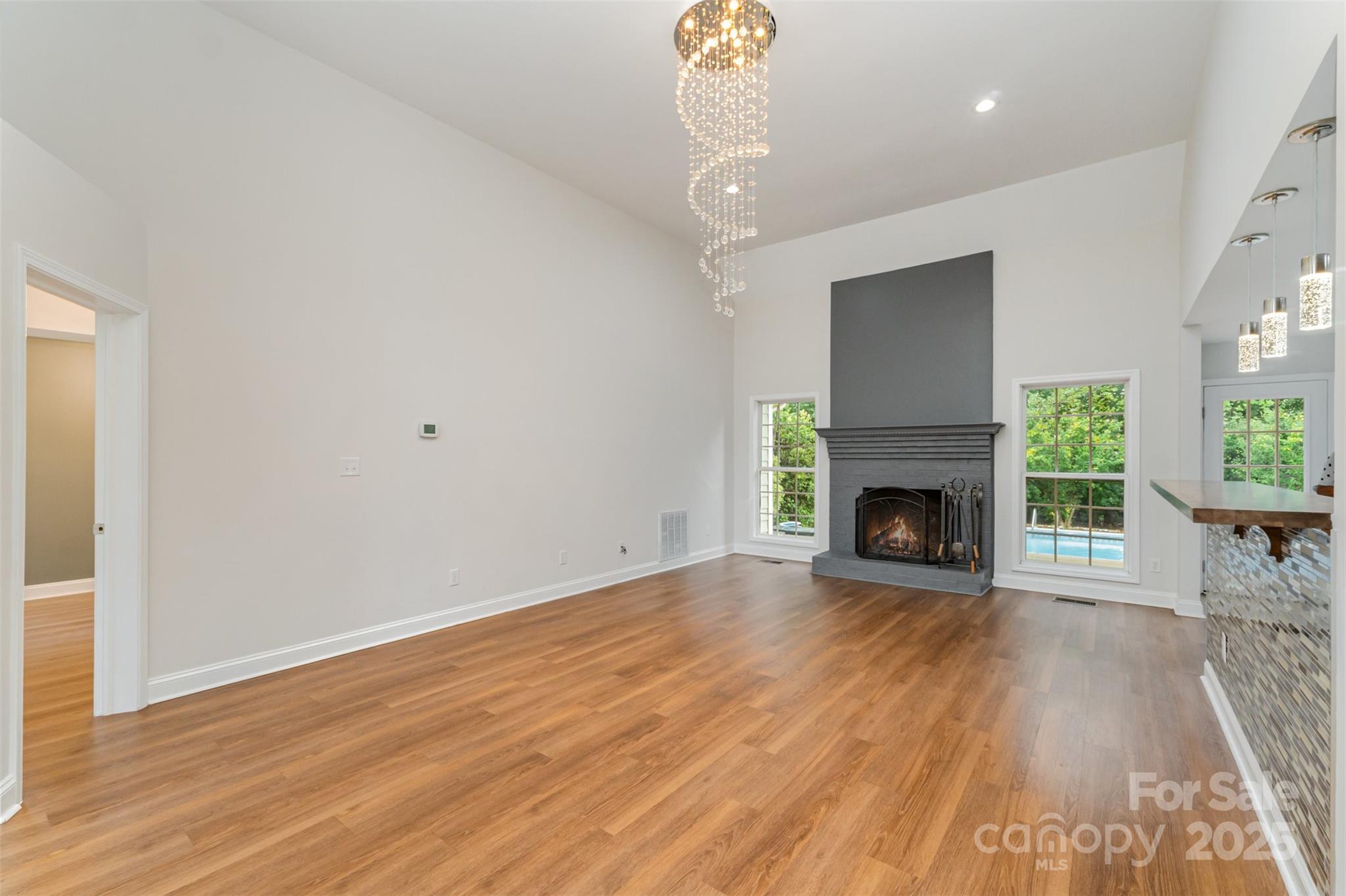 125 Stumpy Creek Road Mooresville, NC 28117 - Photo 4 of 23 a view of an empty room with wooden floor fireplace and a window