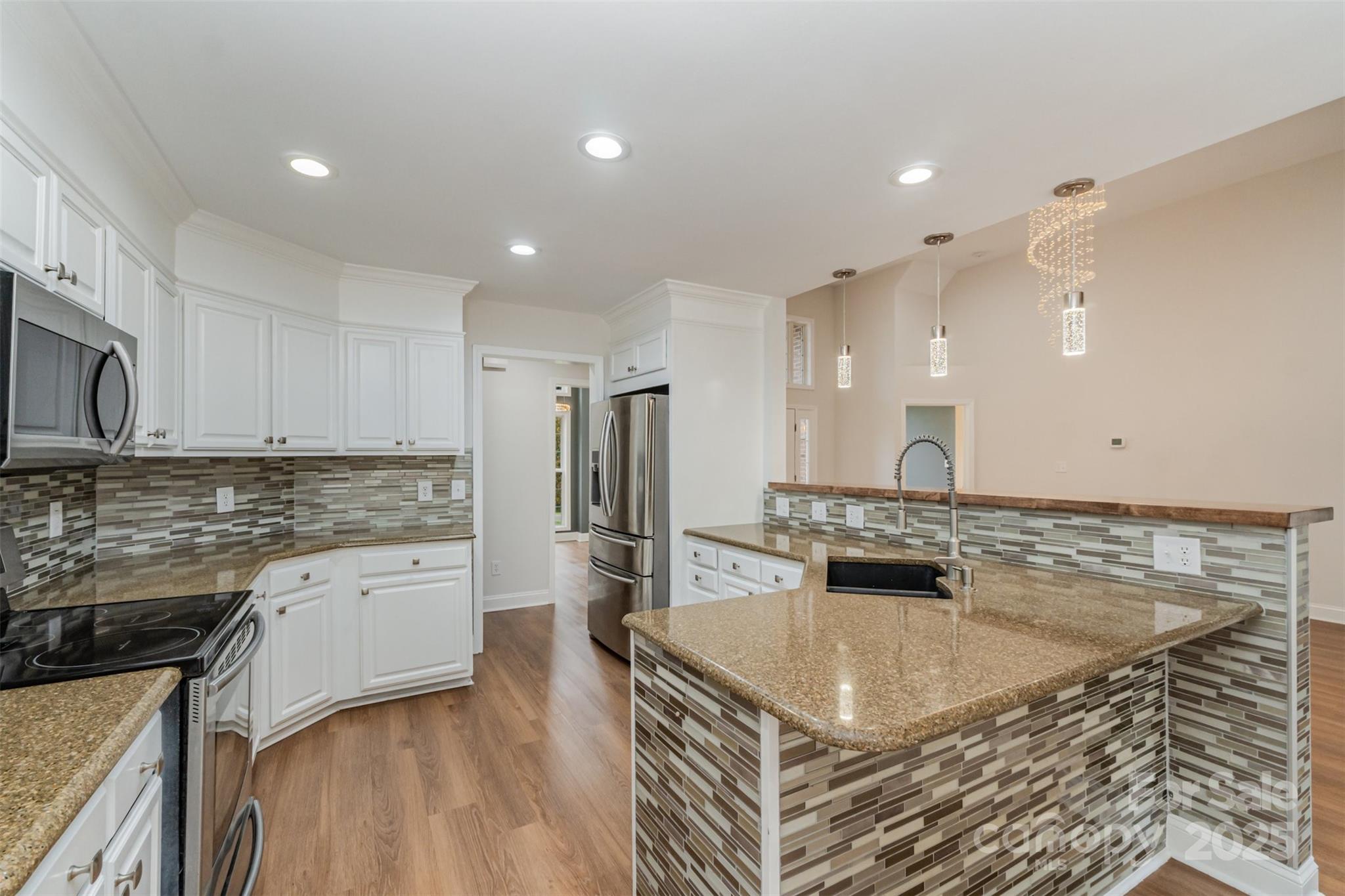 125 Stumpy Creek Road Mooresville, NC 28117 - Photo 6 of 23 a kitchen with stainless steel appliances granite countertop a sink stove and refrigerator