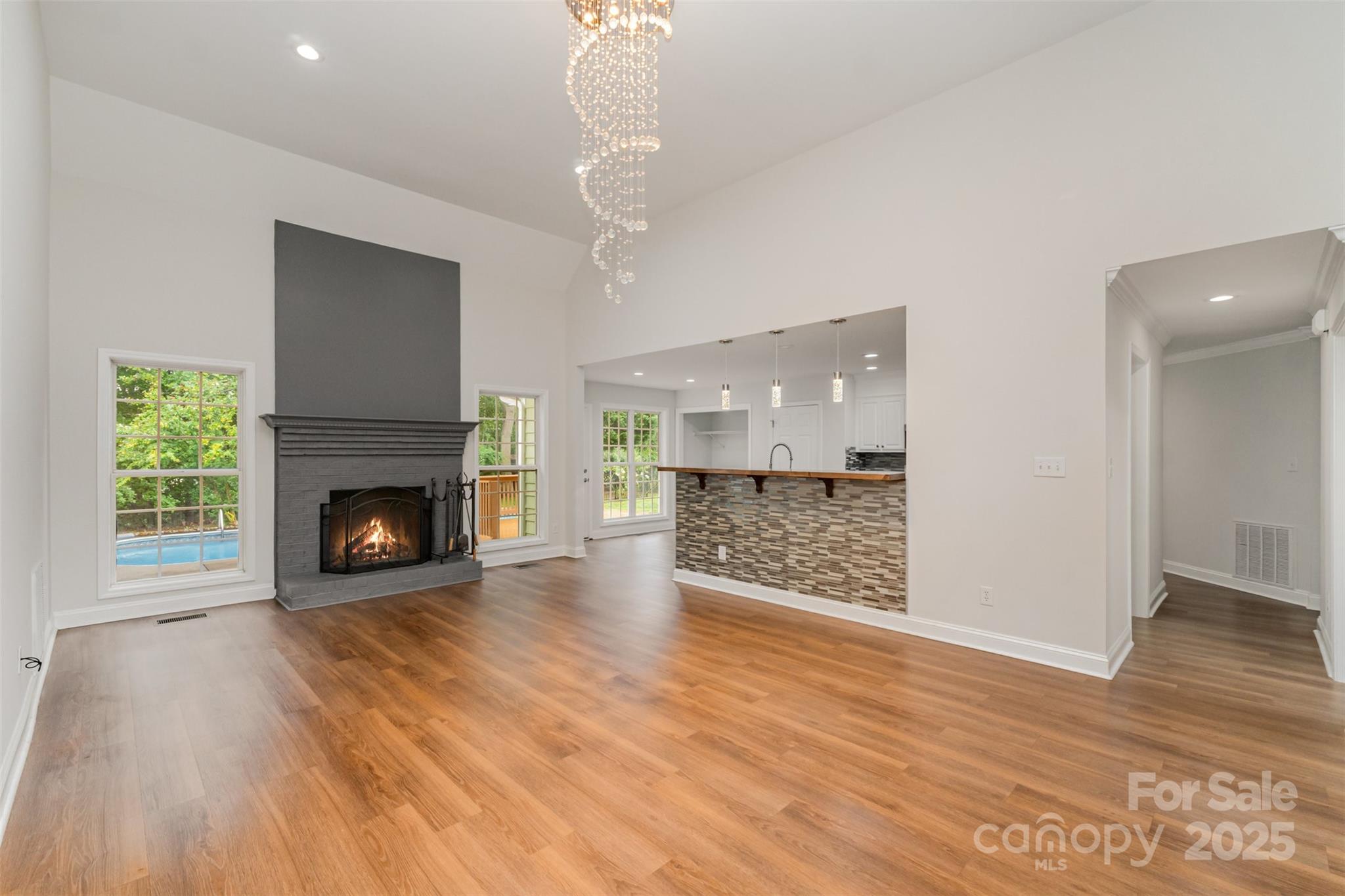 125 Stumpy Creek Road Mooresville, NC 28117 - Photo 8 of 23 a view of a livingroom with wooden floor a fireplace and window