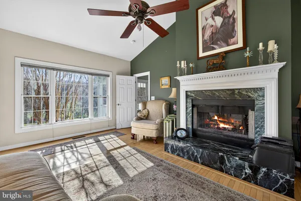 a spacious bedroom with a bed windows and a chandelier