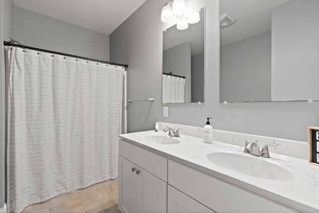 284 Maple Street, Unit 284 Middleton, MA 01949 - Photo 17 of 30 a bathroom with a double vanity sink and a mirror