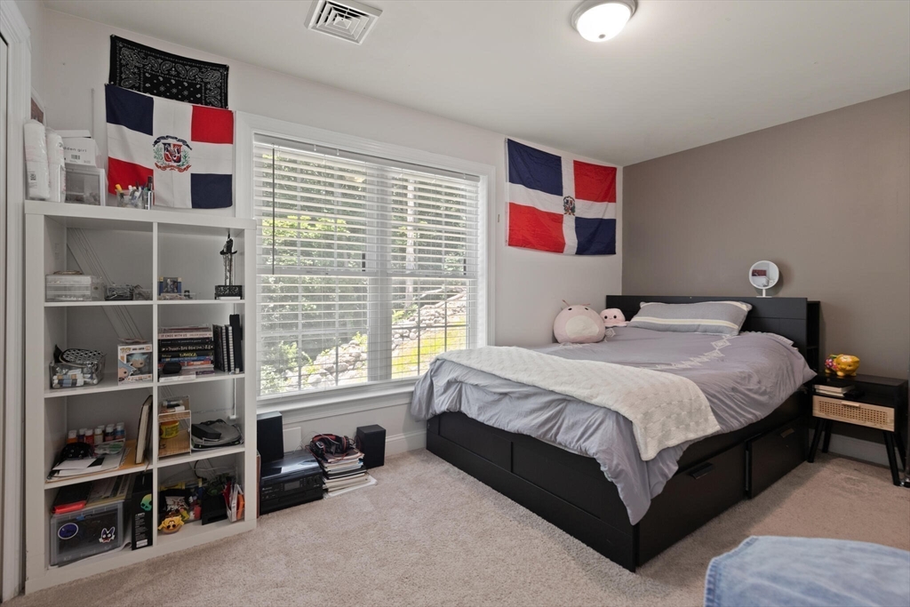 284 Maple Street, Unit 284 Middleton, MA 01949 - Photo 19 of 30 a bedroom with a bed cabinets and a window