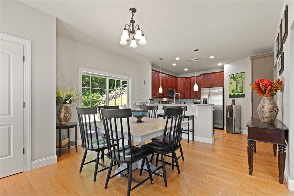 284 Maple Street, Unit 284 Middleton, MA 01949 - Photo 8 of 30 a view of a dining room with furniture window and wooden floor