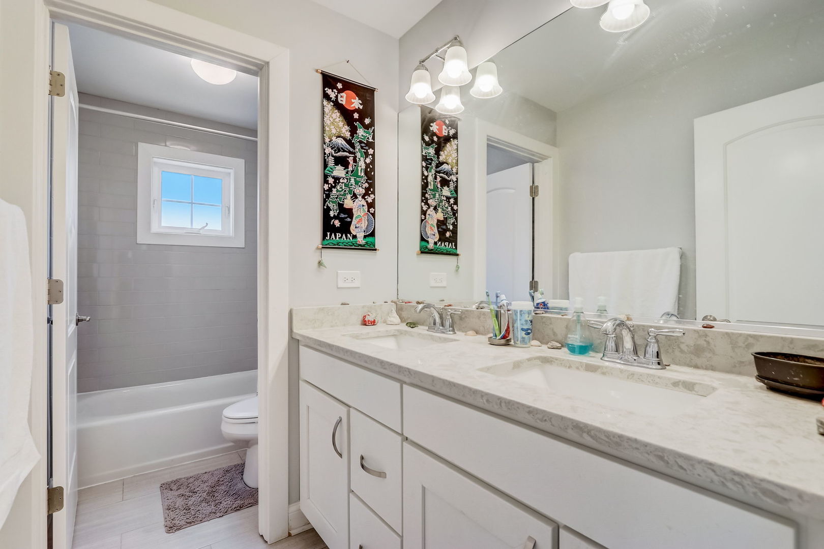 204 Fairbank Road Riverside, IL 60546 - Photo 18 of 35 a bathroom with a double vanity sink a large mirror a bathtub and shower