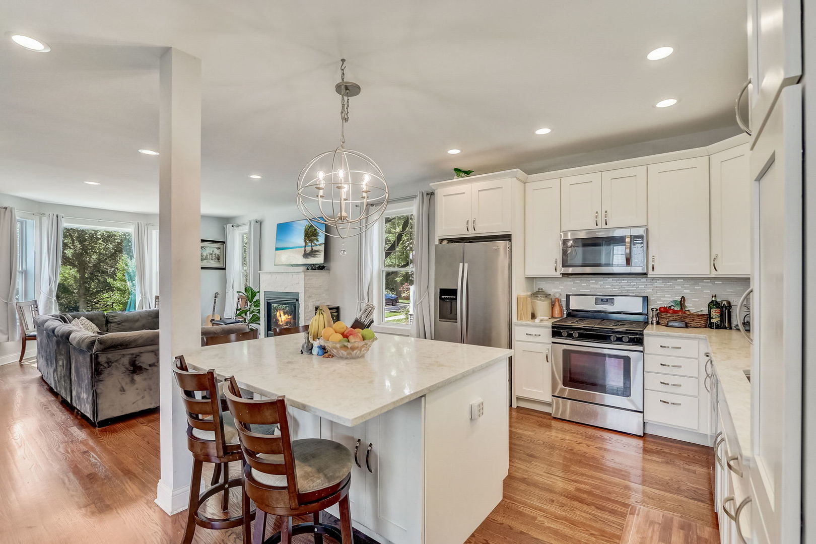 204 Fairbank Road Riverside, IL 60546 - Photo 5 of 35 a kitchen with stainless steel appliances kitchen island granite countertop a refrigerator a stove a sink a dining table and chairs with wooden floor