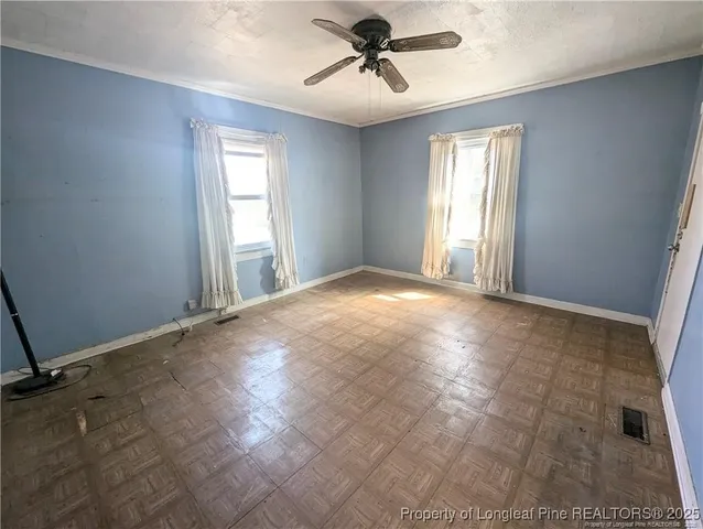 a view of a livingroom with a ceiling fan and window