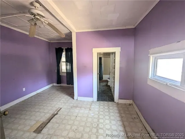 a walk in closet with wooden floor