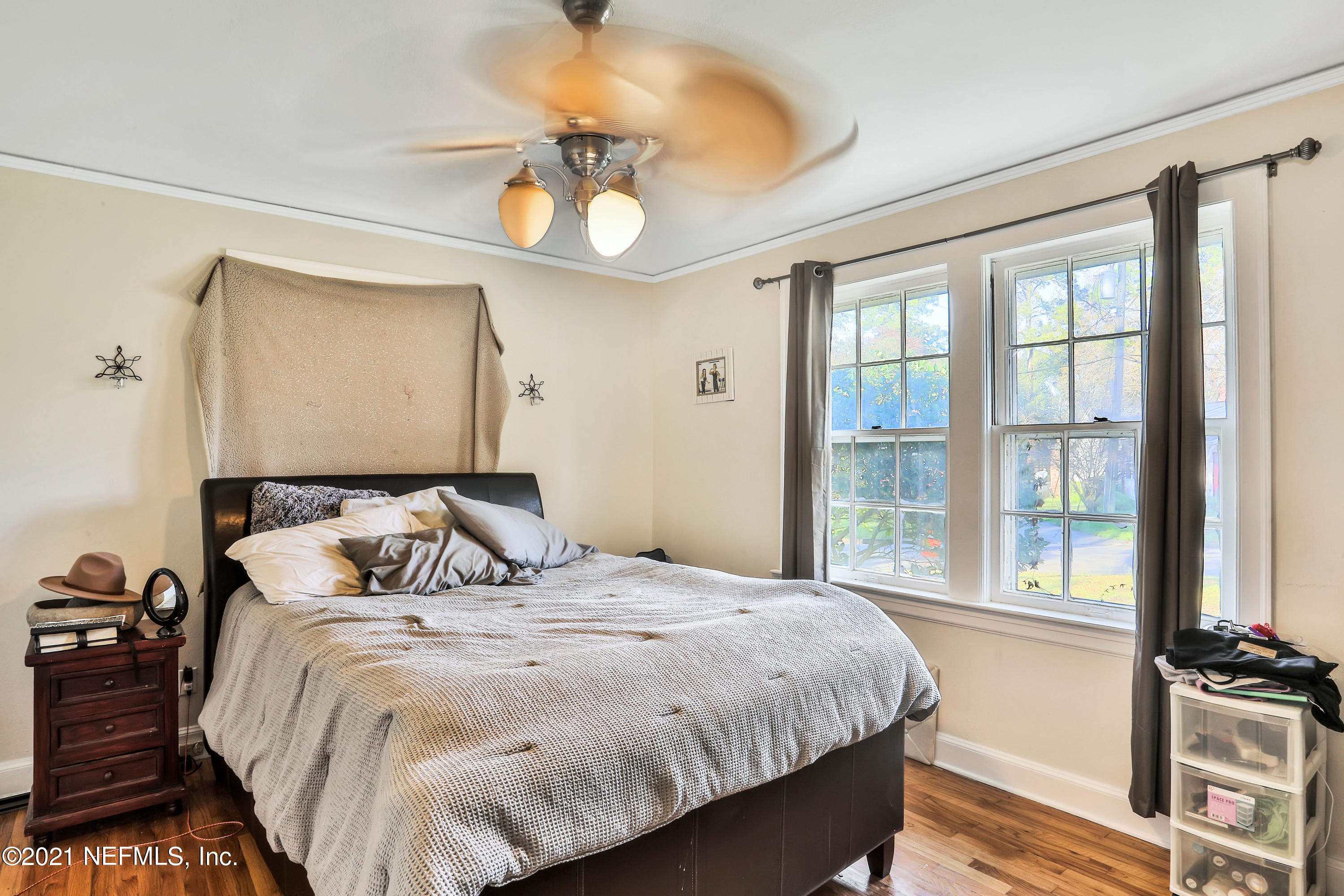 2130 Huntsford Road Jacksonville, FL 32207 - Photo 7 of 11 a bedroom with a bed and a chandelier