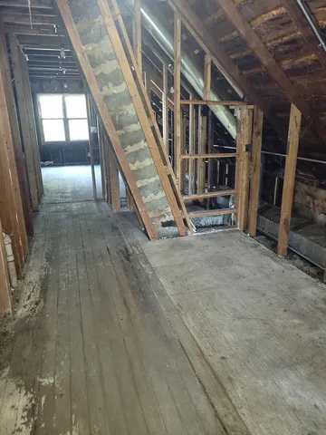 a view of an empty room with stairs