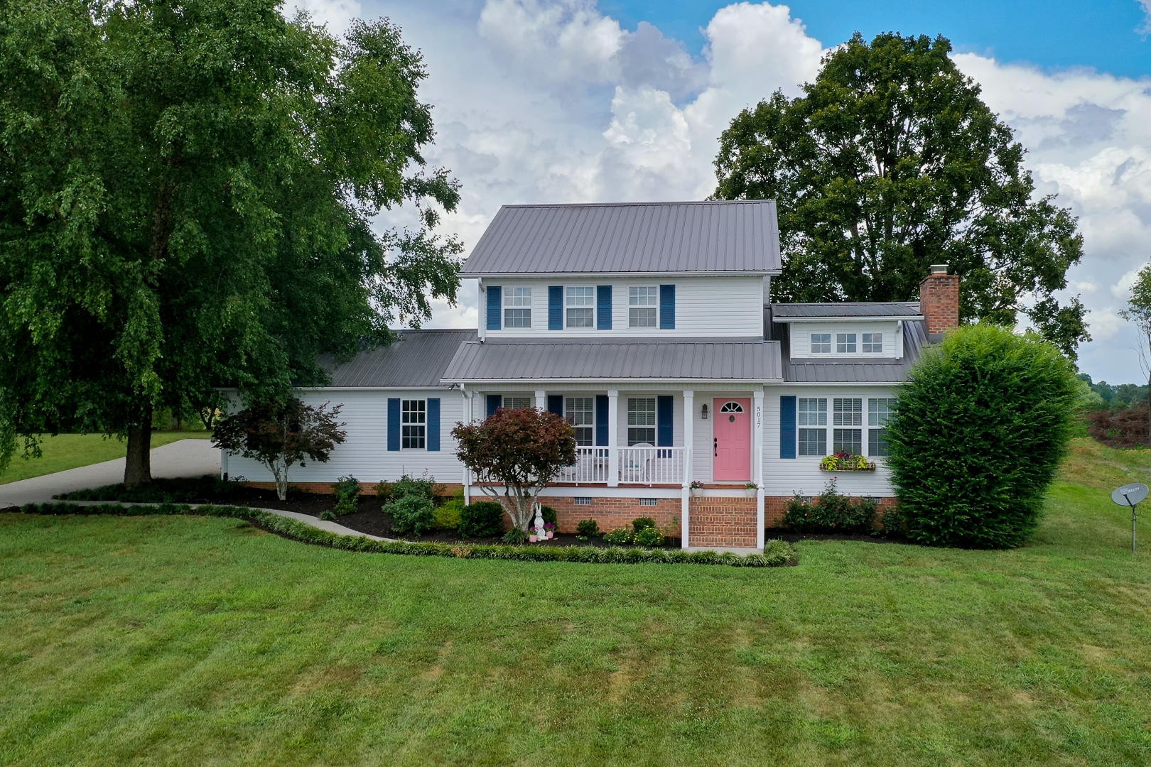 5017 Morganton Road Greenback, TN 37742 - Photo 1 of 40 a front view of a house with a garden and trees
