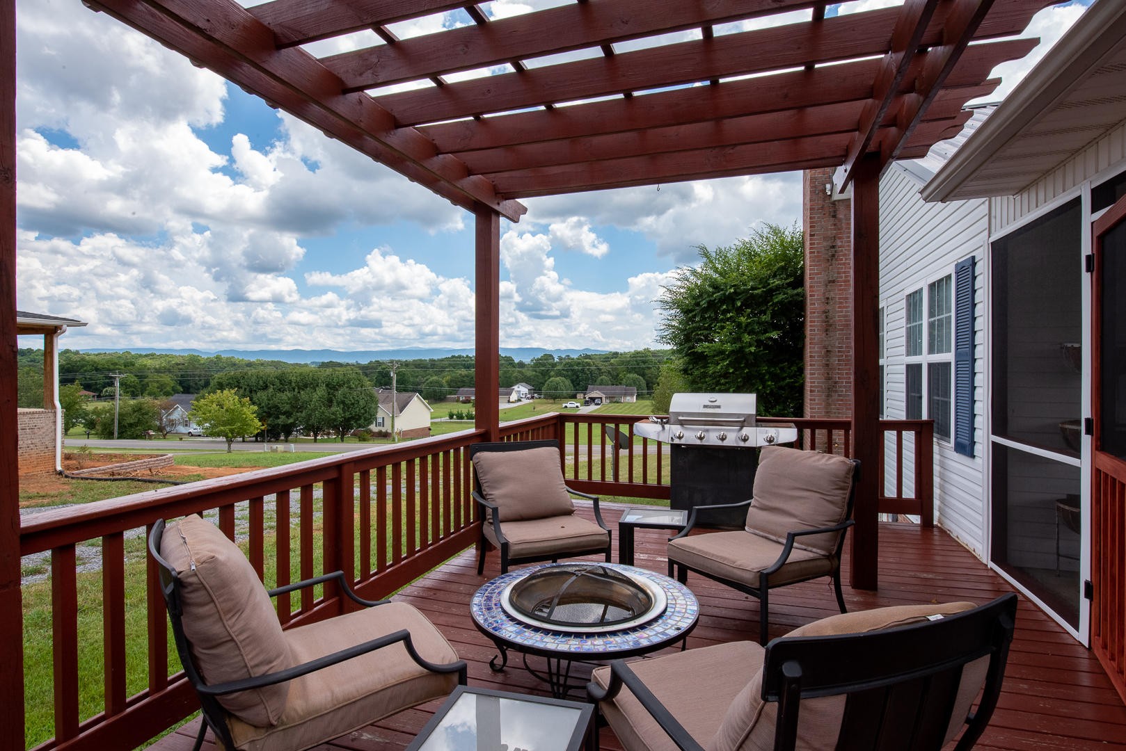 5017 Morganton Road Greenback, TN 37742 - Photo 39 of 40 a view of a patio with couches chairs and a table with wooden floor