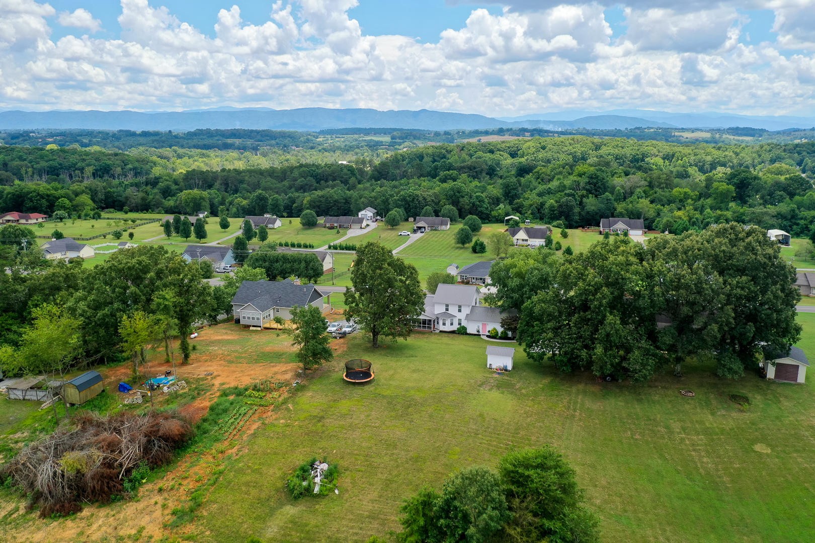 5017 Morganton Road Greenback, TN 37742 - Photo 6 of 40 a view of a garden with a building in the background