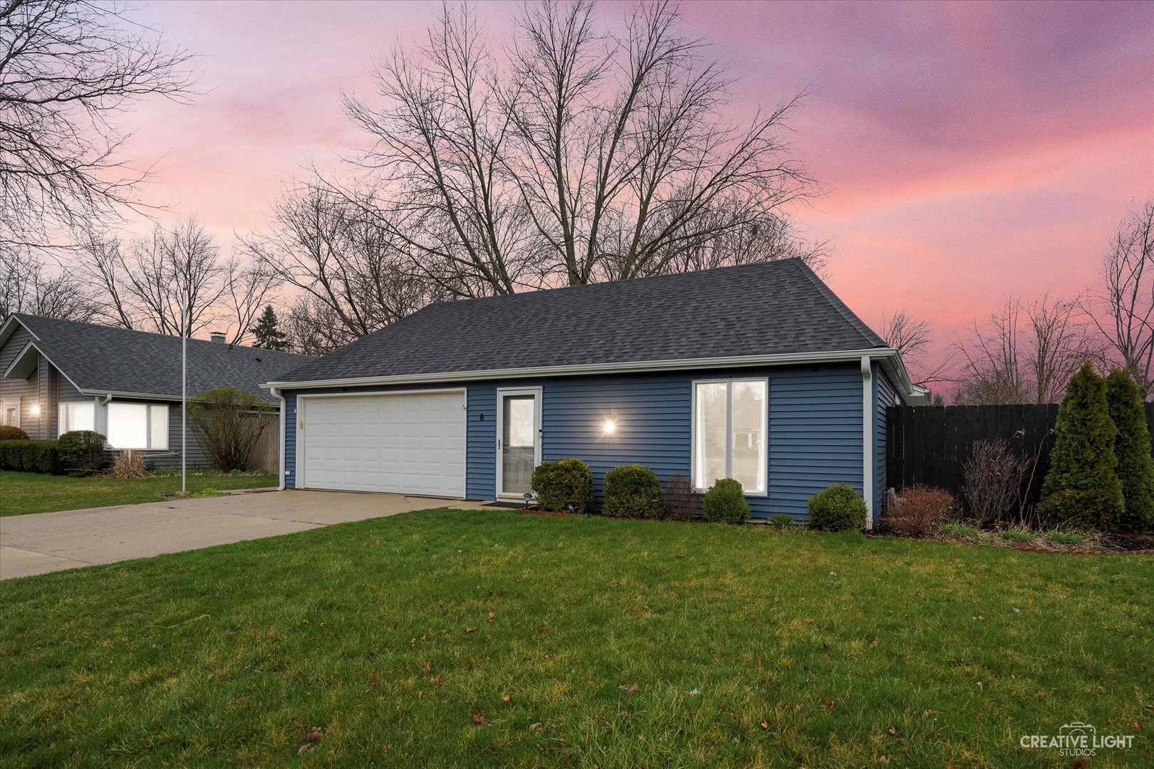 a front view of house with yard and green space