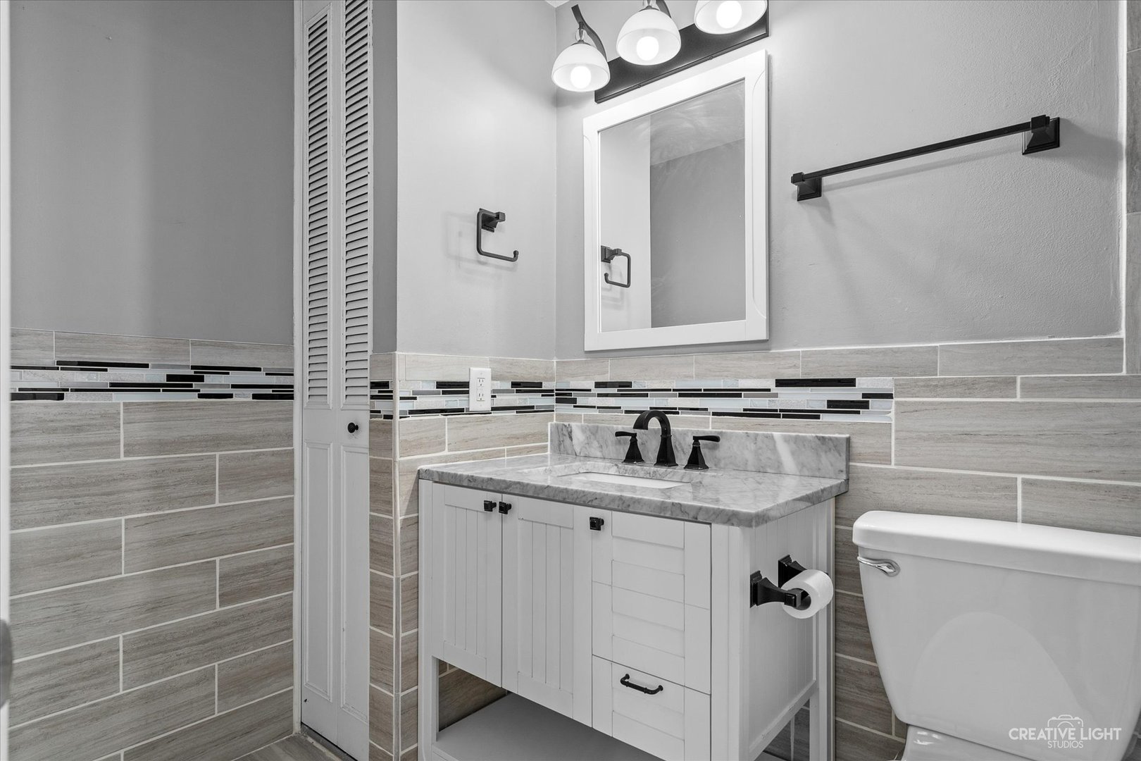 6 Ingleshire Road Montgomery, IL 60538 - Photo 13 of 16 a bathroom with a granite countertop sink a toilet a mirror and shower