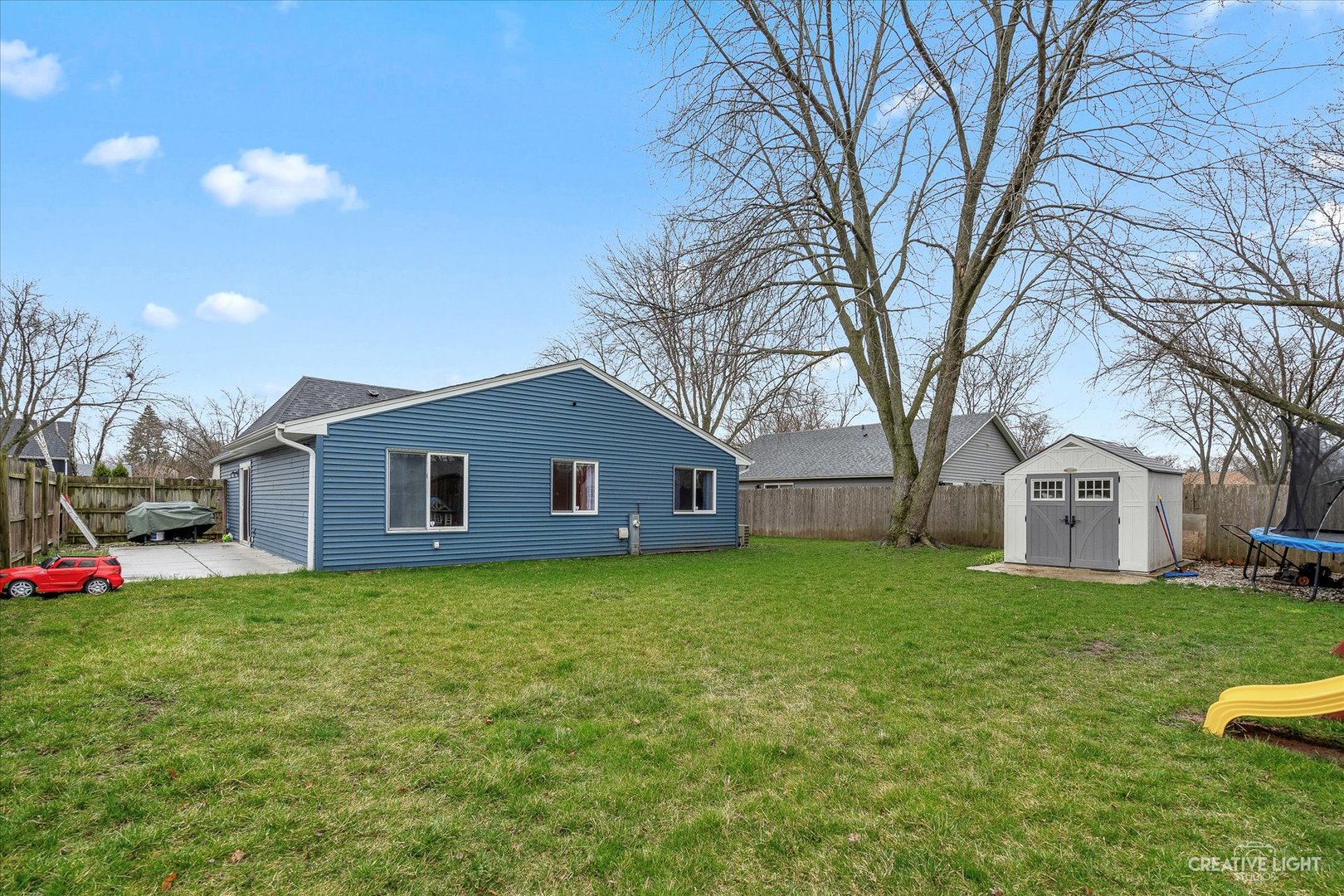 6 Ingleshire Road Montgomery, IL 60538 - Photo 16 of 16 a house that is sitting in the grass with large trees and plants