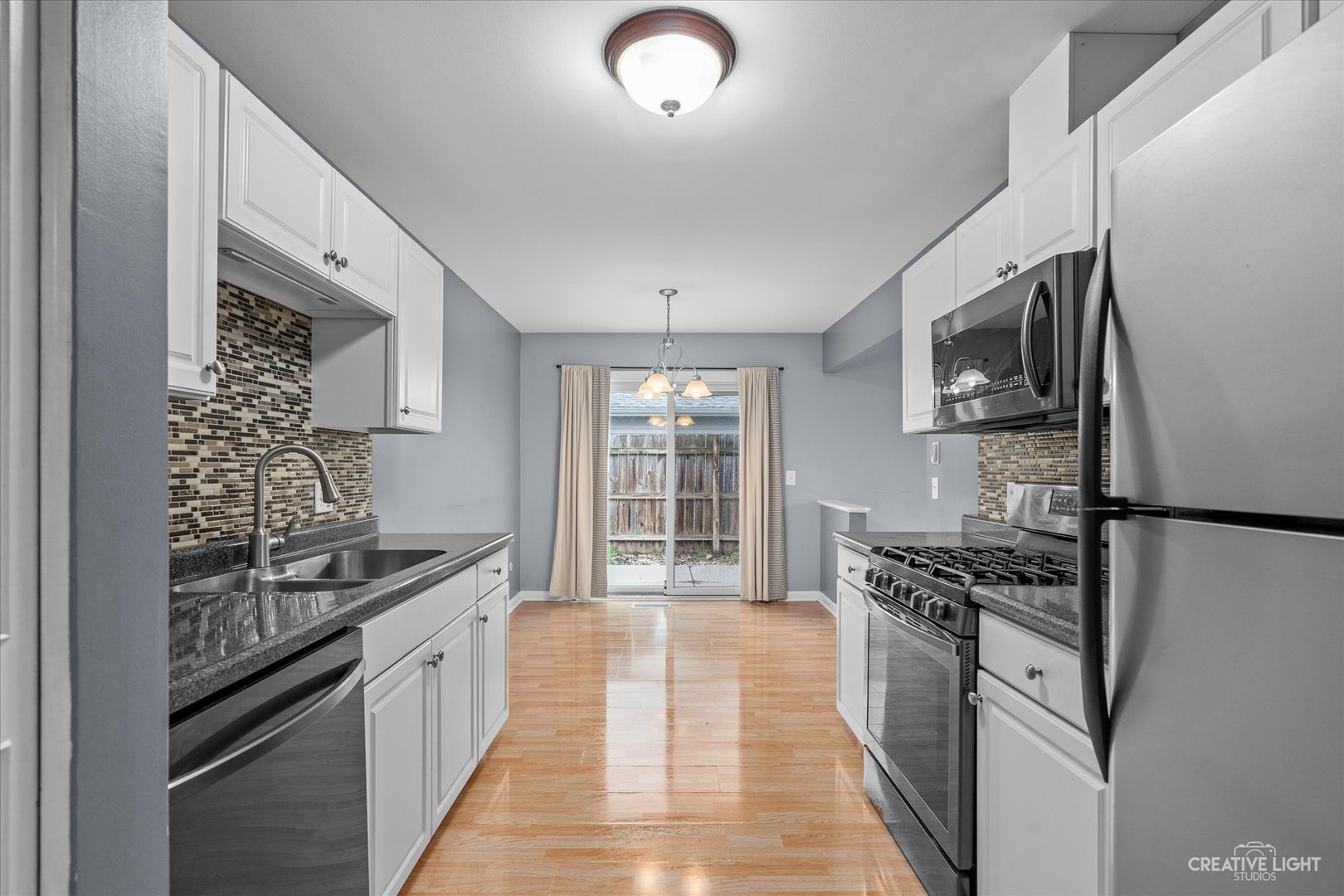 6 Ingleshire Road Montgomery, IL 60538 - Photo 7 of 16 a kitchen with stainless steel appliances granite countertop a stove and a refrigerator