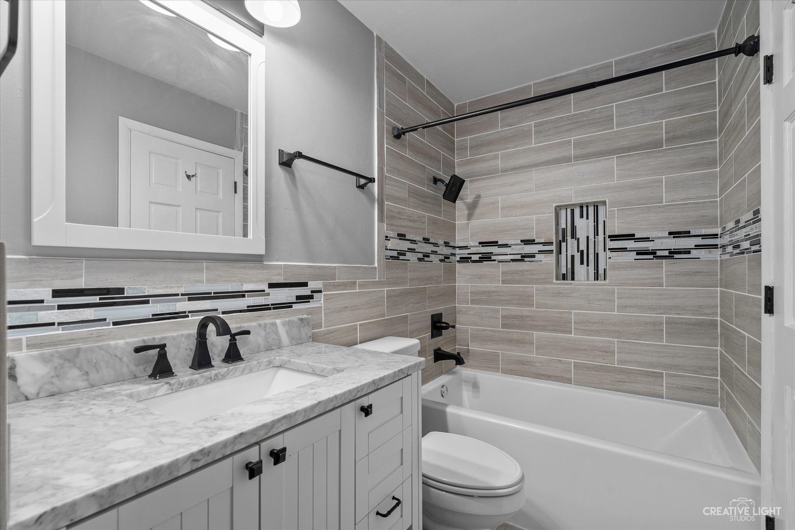 6 Ingleshire Road Montgomery, IL 60538 - Photo 10 of 16 a bathroom with a granite countertop sink a toilet a mirror and bathtub