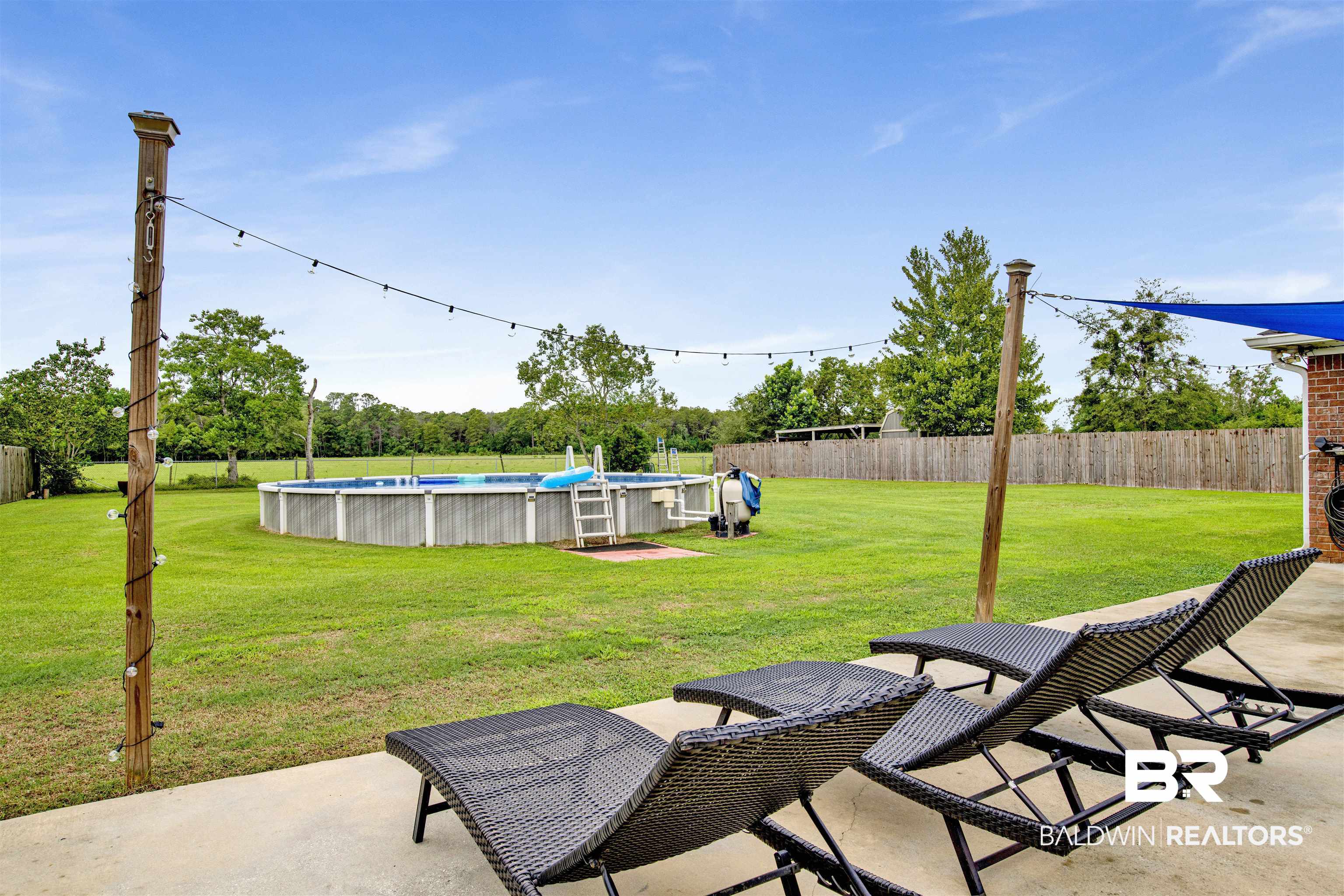 17483 East View Loop Foley, AL 36535 - Photo 28 of 30 View of patio featuring a fenced in pool