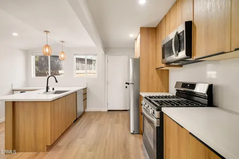 a kitchen that has a sink and a stove