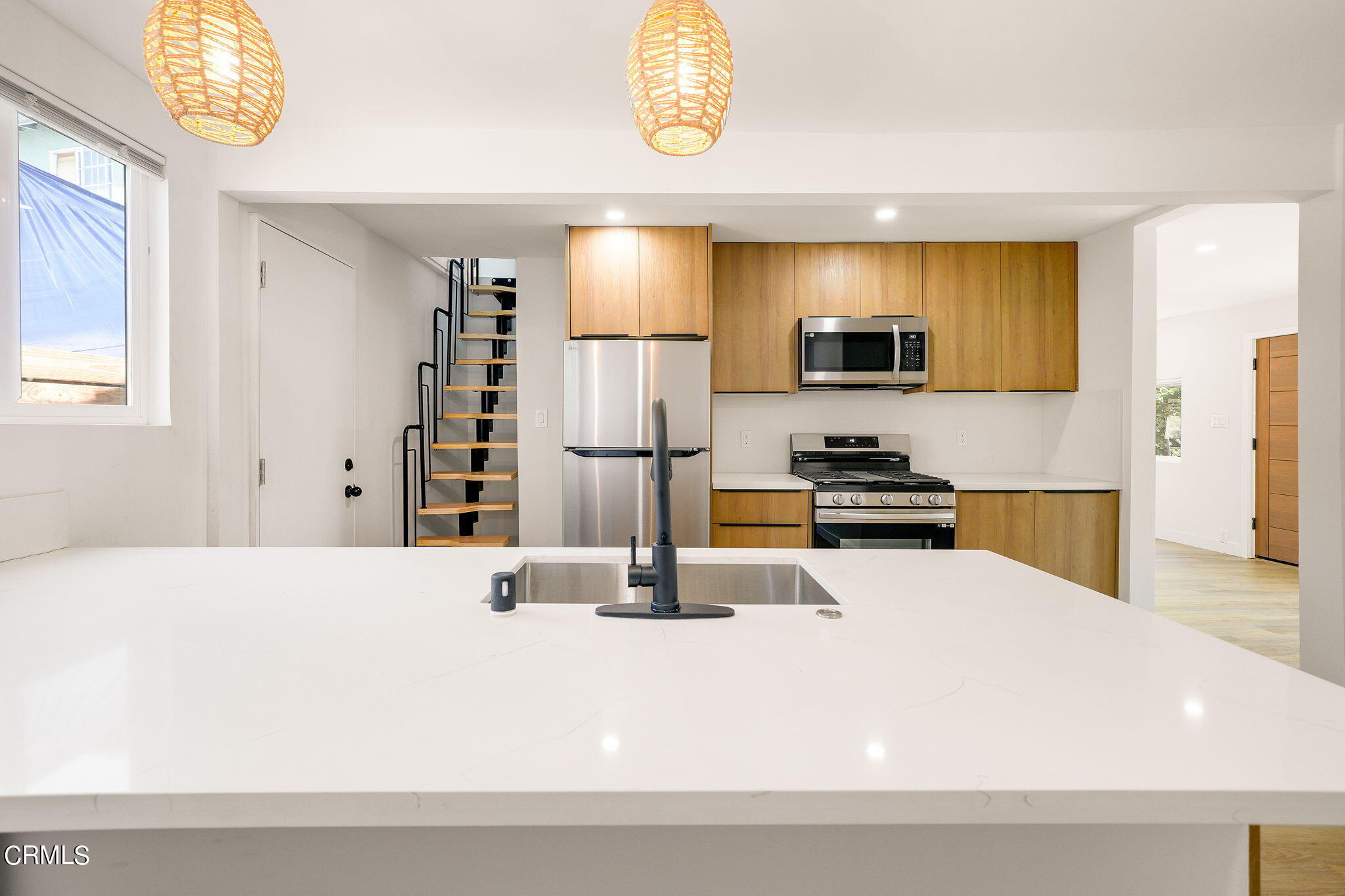 2138 1/2 Santa Ynez Street Los Angeles, CA 90026 - Photo 15 of 22 a kitchen with stainless steel appliances kitchen island granite countertop a refrigerator and a stove top oven