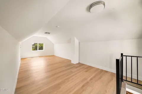 a view of a room with wooden floor and a window