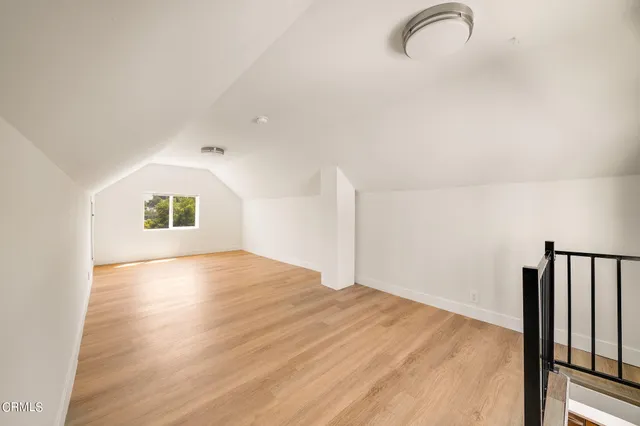 a view of a room with wooden floor and a window