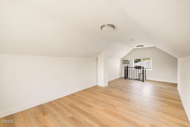 a view of a room with wooden floor and window