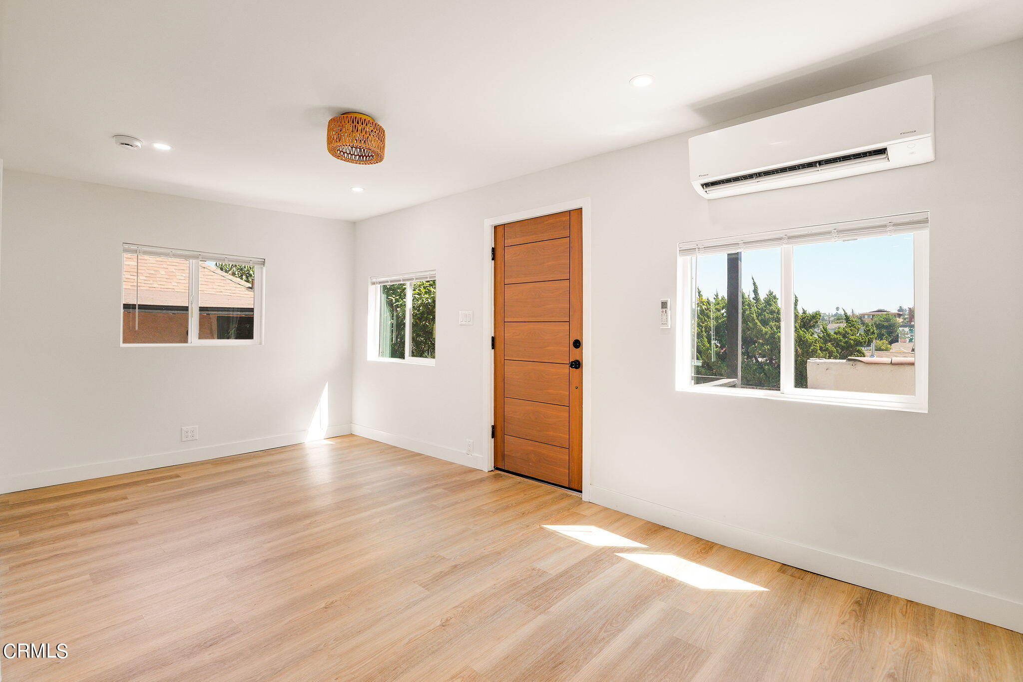 2138 1/2 Santa Ynez Street Los Angeles, CA 90026 - Photo 3 of 22 an empty room with wooden floor and windows