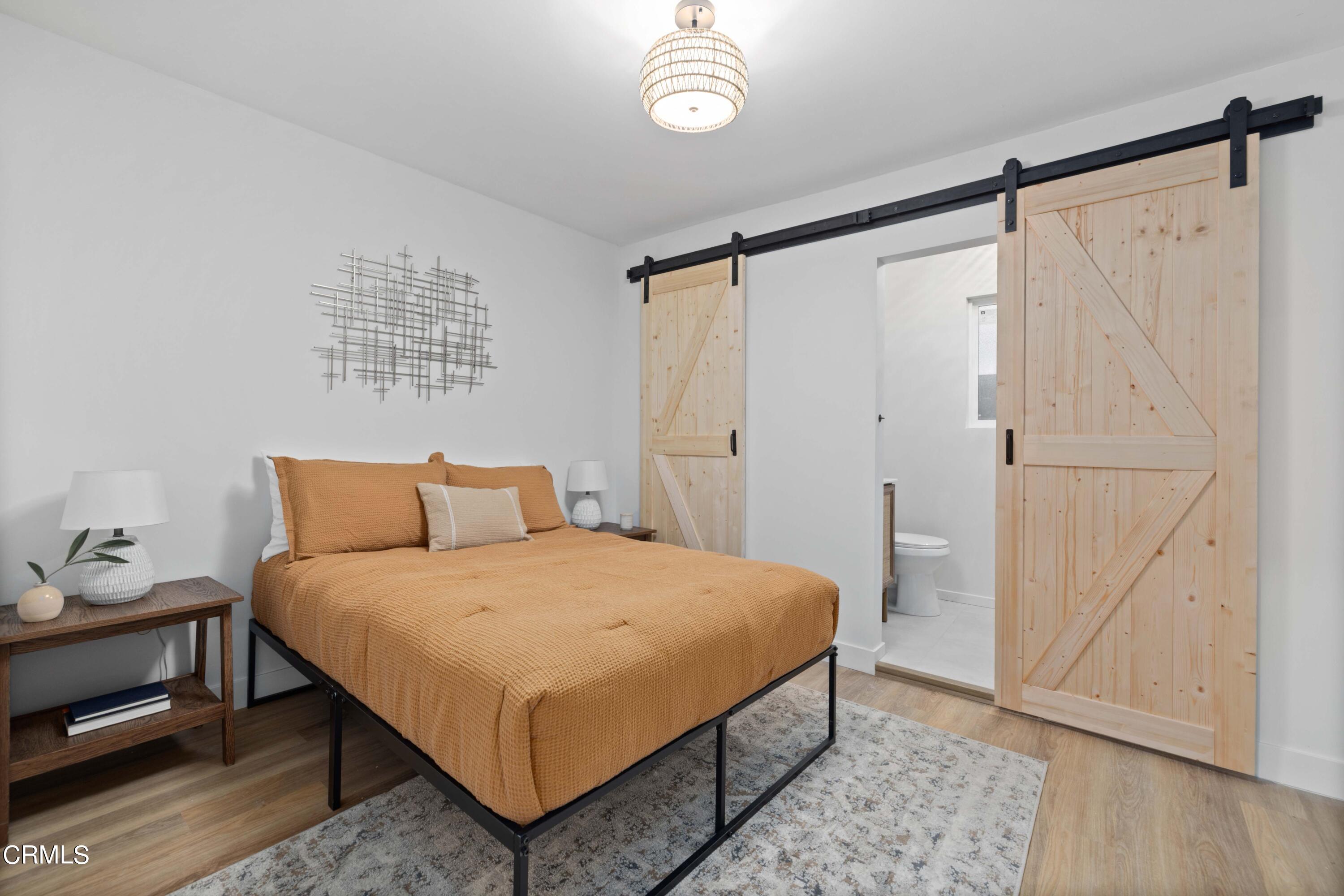 2138 1/2 Santa Ynez Street Los Angeles, CA 90026 - Photo 8 of 22 a bedroom with a bed and a window