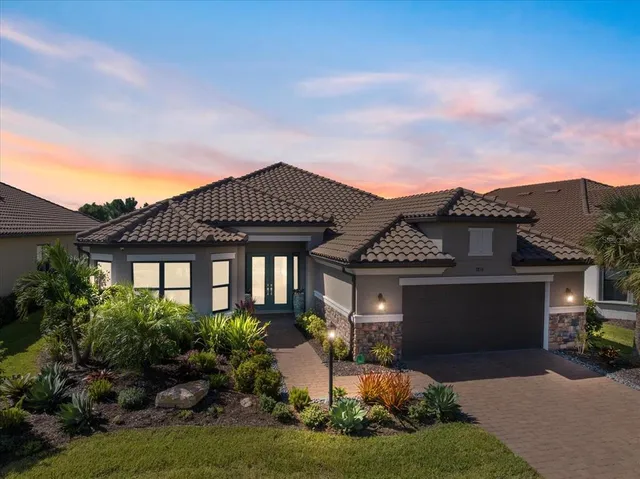 a front view of a house with a garden