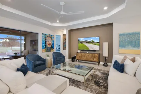 a kitchen with stainless steel appliances kitchen island granite countertop a table chairs sink and cabinets