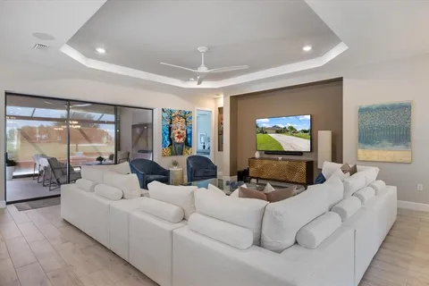 a kitchen with stainless steel appliances granite countertop a table chairs sink refrigerator and cabinets